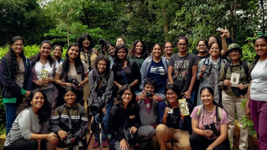 Photograph of women birdwatchers posing with binocs and spotting scope in Bangalore